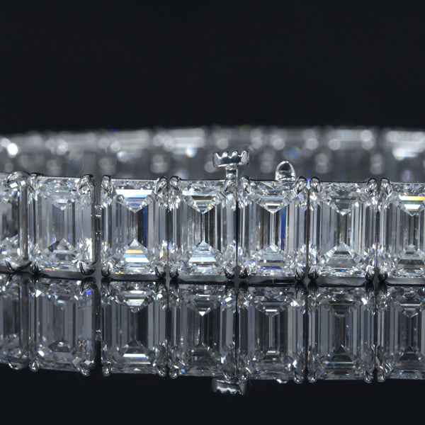 Emerald cut diamond tennis bracelet in white gold close up view