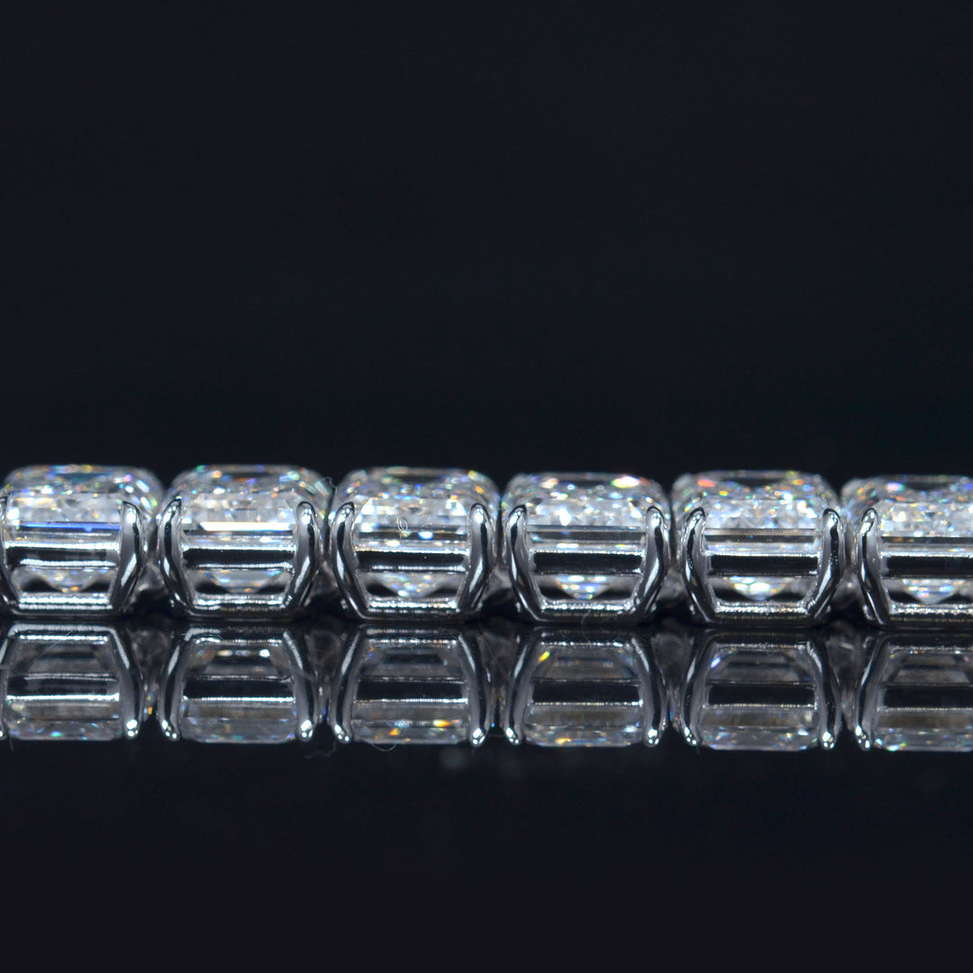 Emerald cut diamond tennis bracelet in white gold close up side view