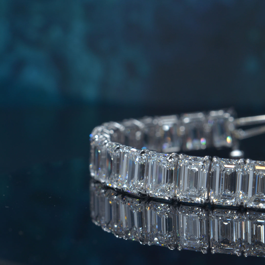 Emerald cut diamond tennis bracelet in white gold close up view