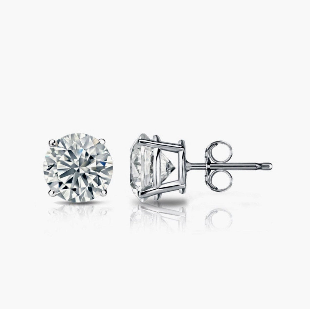 Two diamond stud earrings on a white background