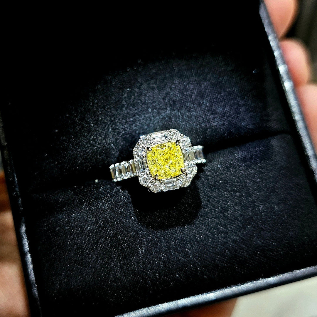 Cushion Yellow diamond with Halo baguette and Round cut Ring in white gold in a ring box