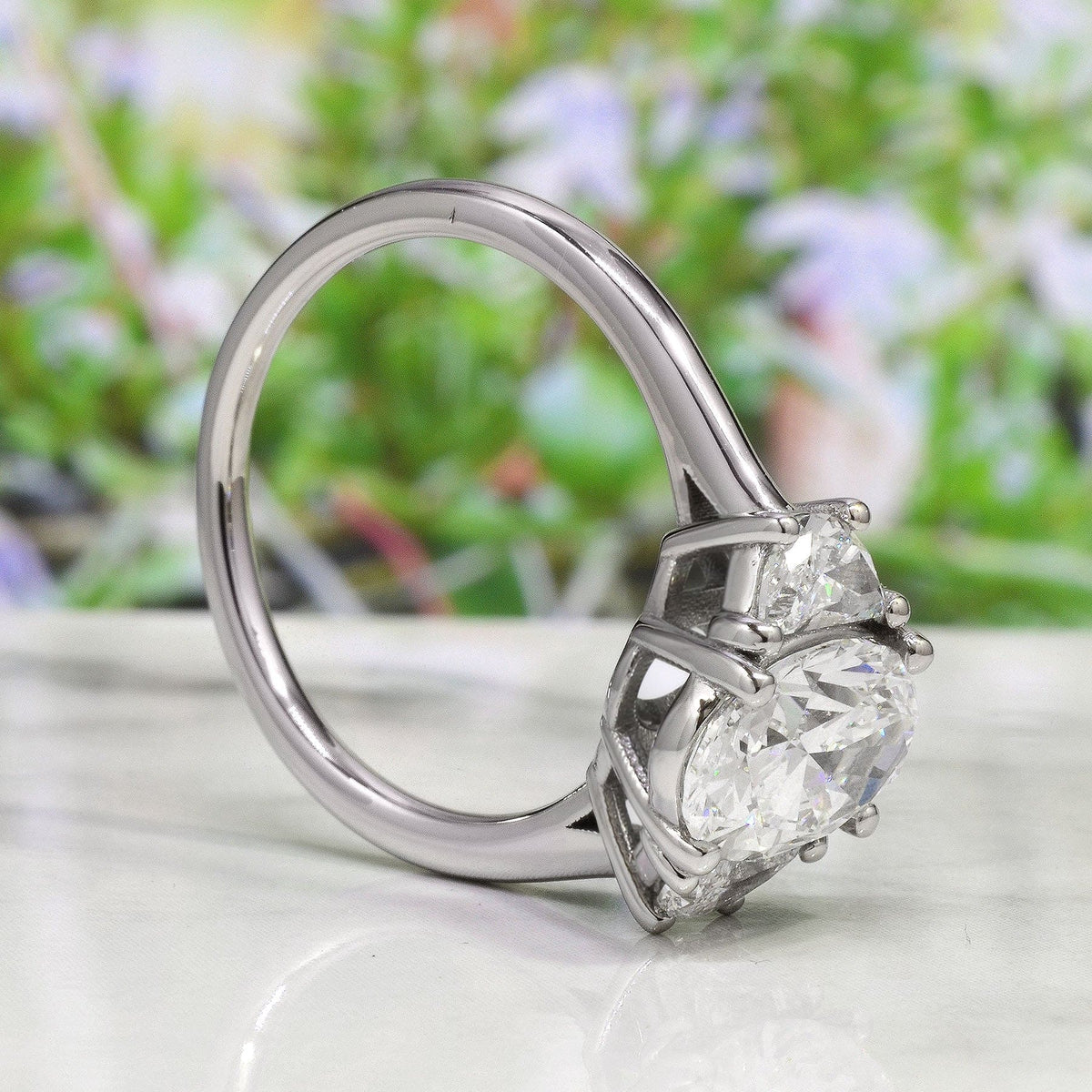Oval cut 3 stone with half moon diamond ring in white gold side profile