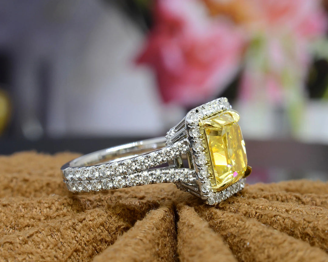 square radiant cut yellow diamond set at the center of a halo split‑shank ring, crafted in white gold and secured with yellow‑gold prongs side view