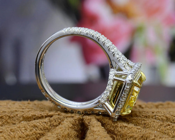 square radiant cut yellow diamond set at the center of a halo split‑shank ring, crafted in white gold and secured with yellow‑gold prongs side profile