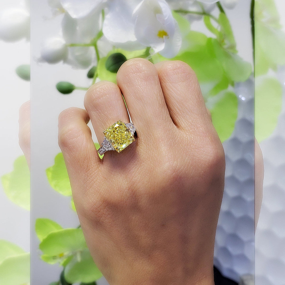 Yellow radiant cut engagement ring on hand