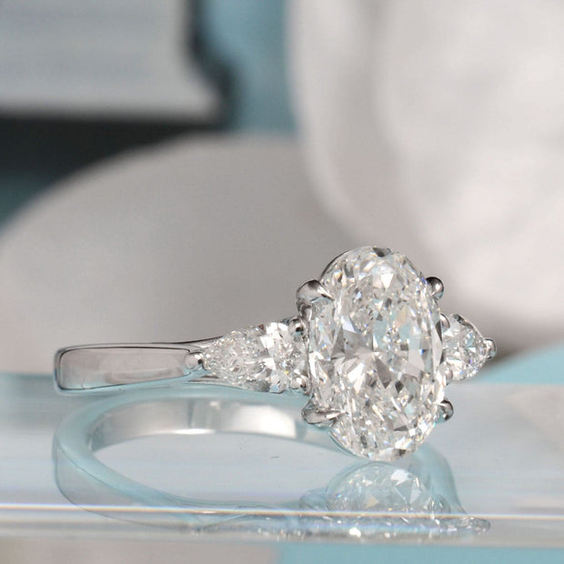 oval cut with pear cut diamond 3 stone ring side 1view