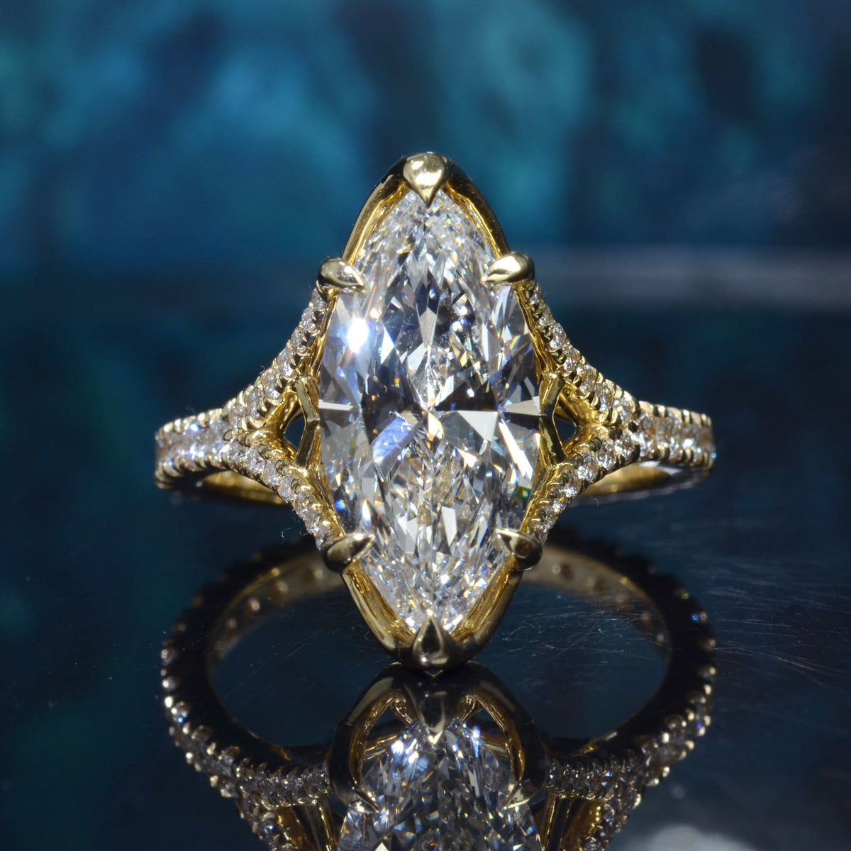 Marquise diamond  round u pave split shank ring in yellow gold top view
