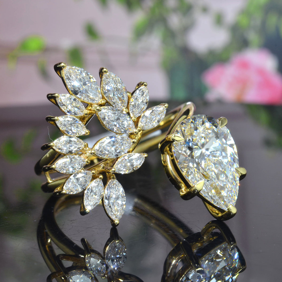 Pear cut and marquise cluster diamond bypass ring in yellow gold front view