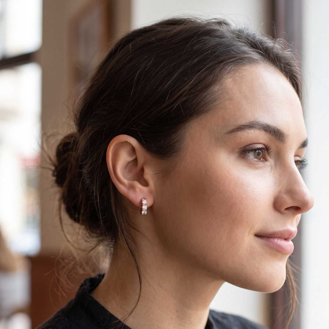 3 stone Round cut Huggie Hoop earrings Usetting in rose gold on a lady model