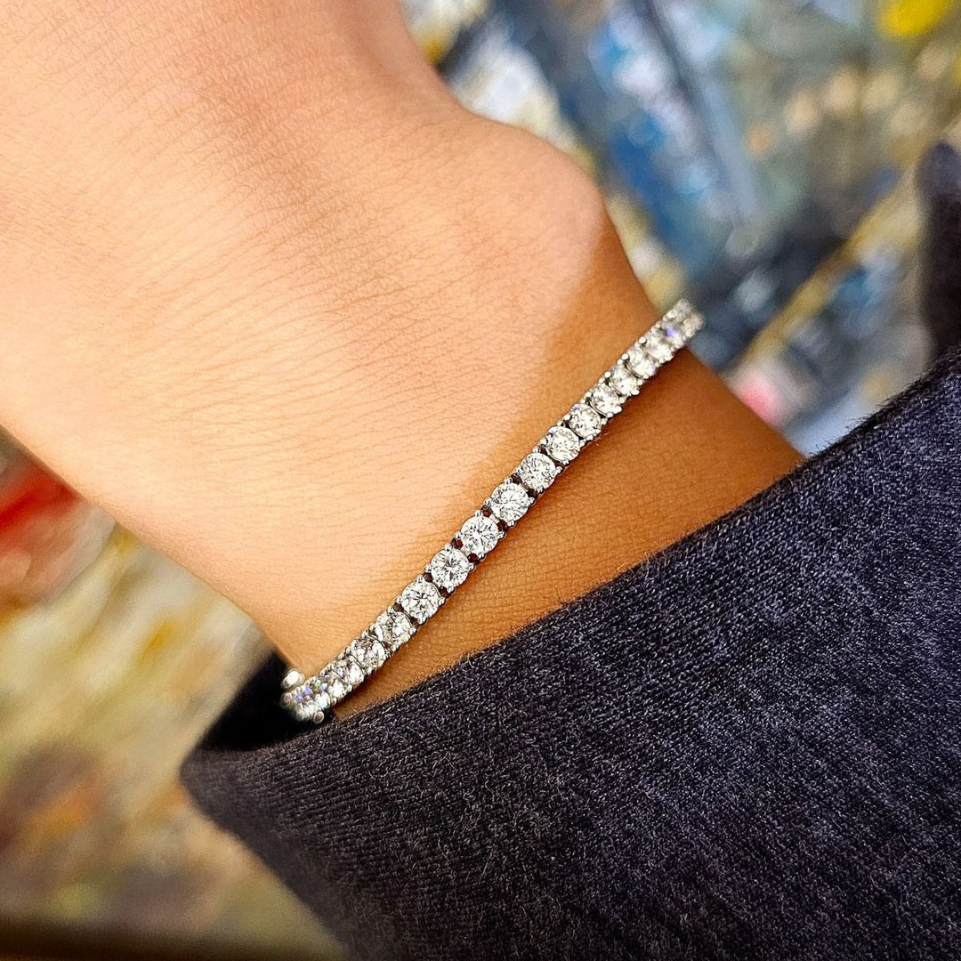 A tennis bracelet featuring round cut natural diamonds 6 carat total weight on wrist modern 