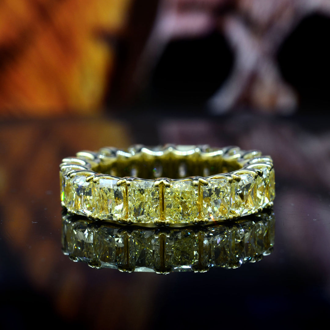 Gold ring with diamond accents on a reflective surface