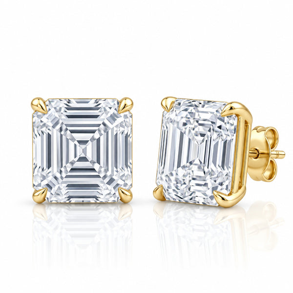 A pair of square emerald-cut diamond stud earrings in yellow gold settings, shown from the front and side on a reflective white background.