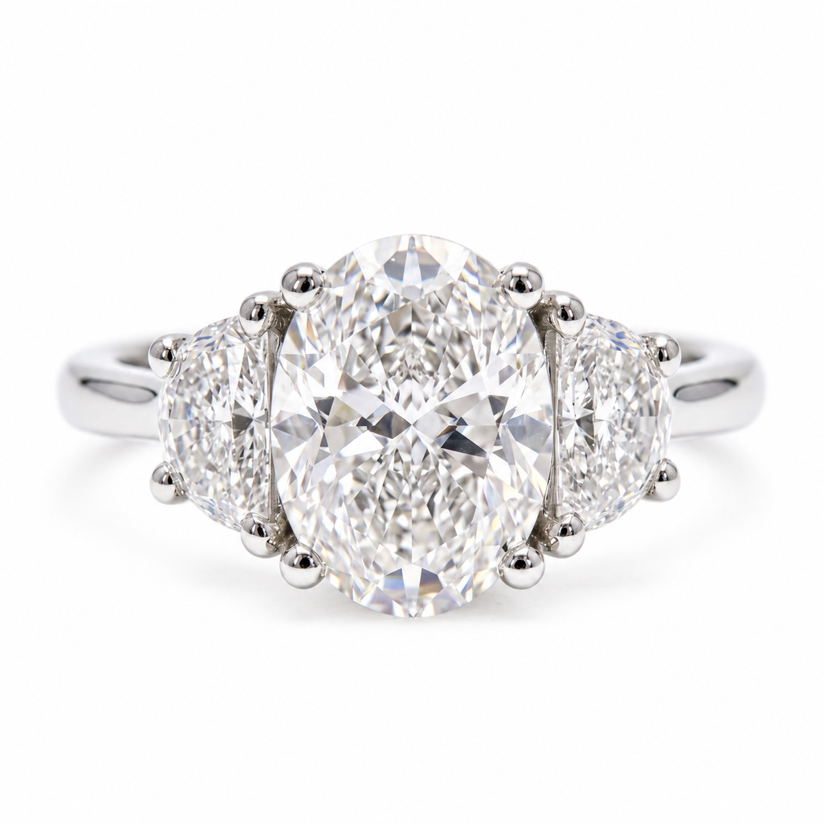 Classic_three stone_oval_diamond_ring_with_half_moon_side_diamonds
