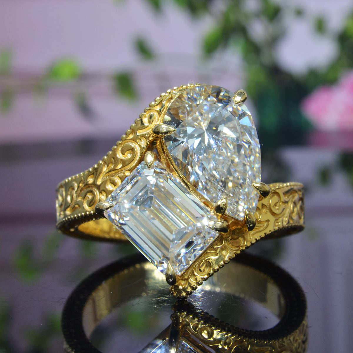 Toi et moi emerald & pear diamond bypass ring with engraving details on shank  in yellow gold front view