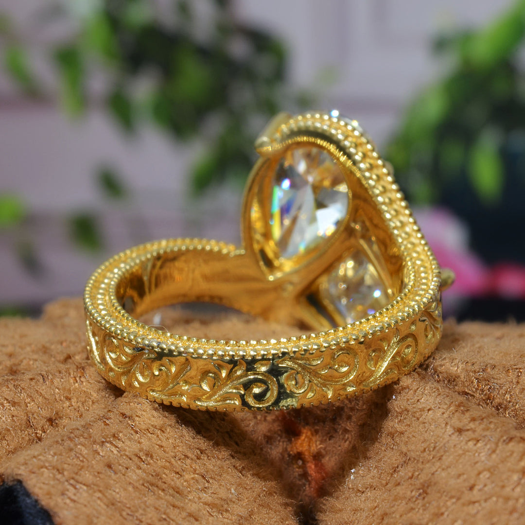 Toi et Moi Emerald & Pear Diamond Bypass Ring with engraving details on shank  in yellow gold bottom view