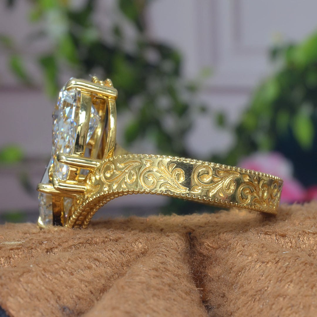 Toi et Moi Emerald & Pear Diamond Bypass Ring with engraving details on shank  in yellow gold side view