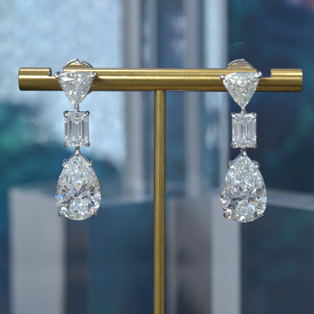 Pear cut, emerald cut and trillion diamond dangling earrings in white gold
