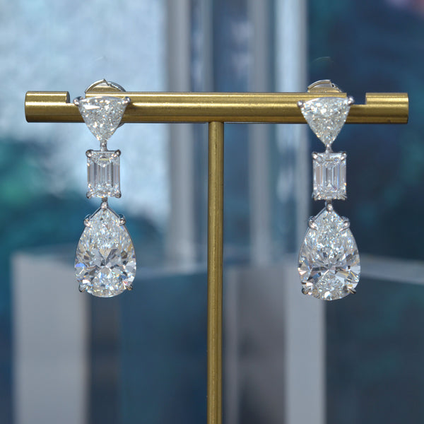Pear cut, emerald cut and trillion diamond dangling earrings in white gold