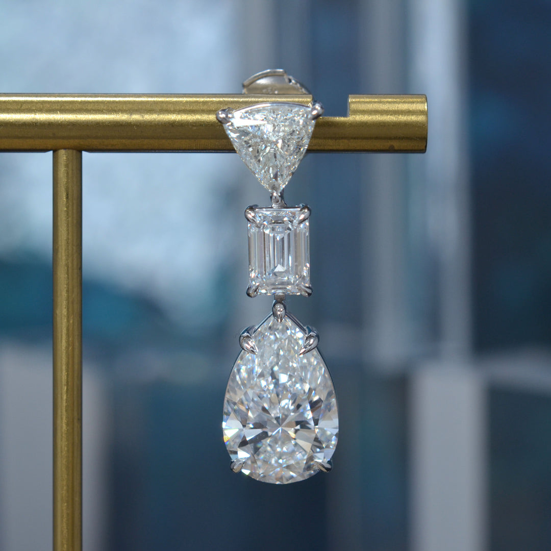 Pear cut, emerald cut and trillion diamond dangling earring in white gold