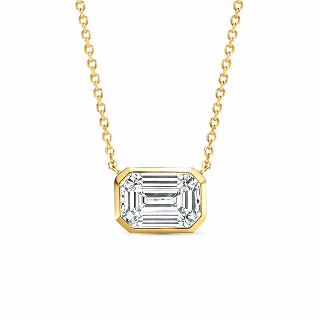 Diamond bezel emerald cut east west pendant necklace in yellow gold front view
