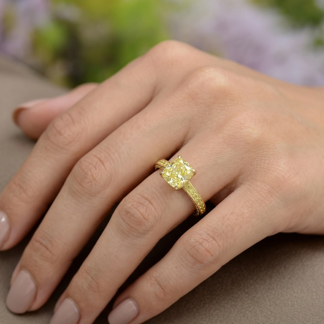Gold ring with a diamond on a hand against a blurred floral background
