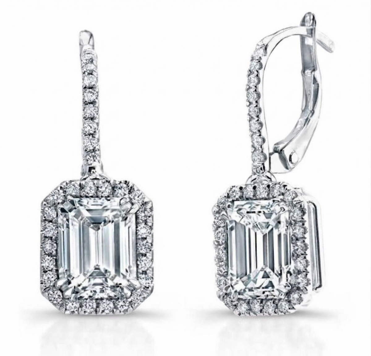 Diamond earrings with emerald cut stones on a white background