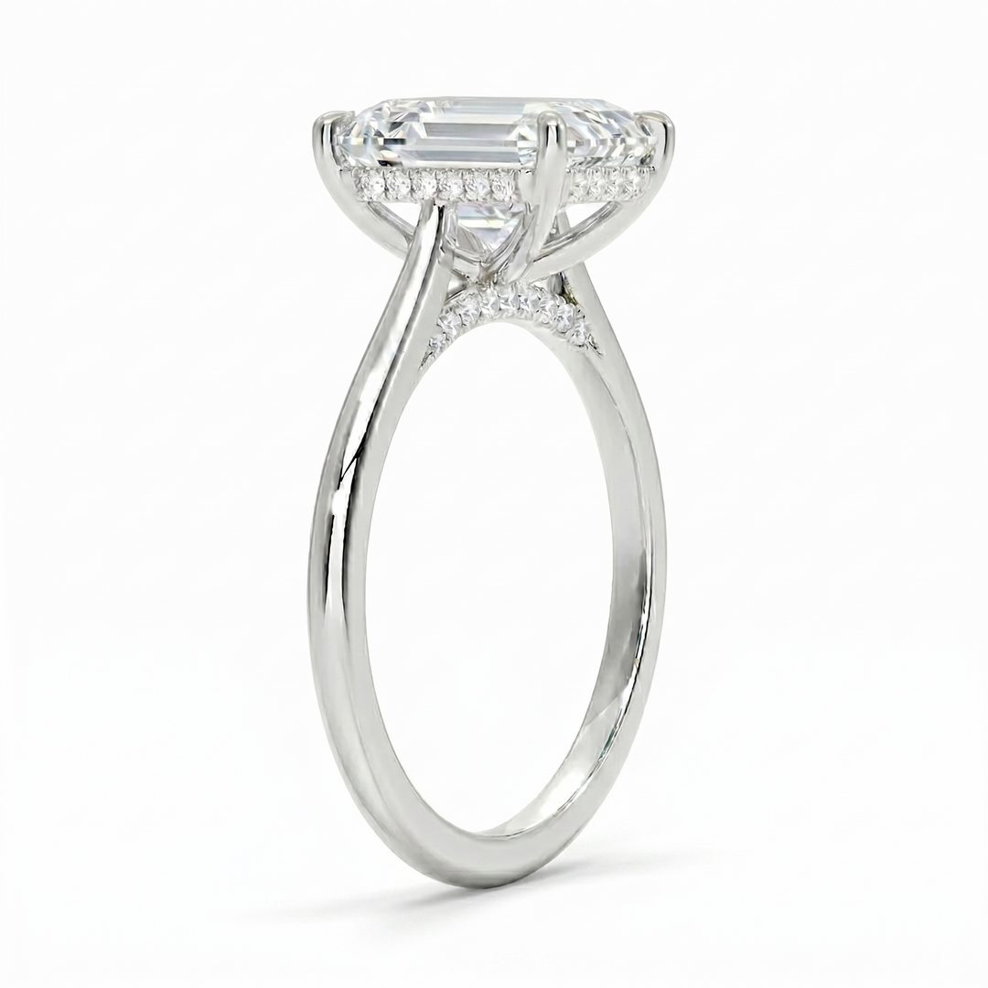 Hidden halo Emerald cut center diamond ring in white gold side profile