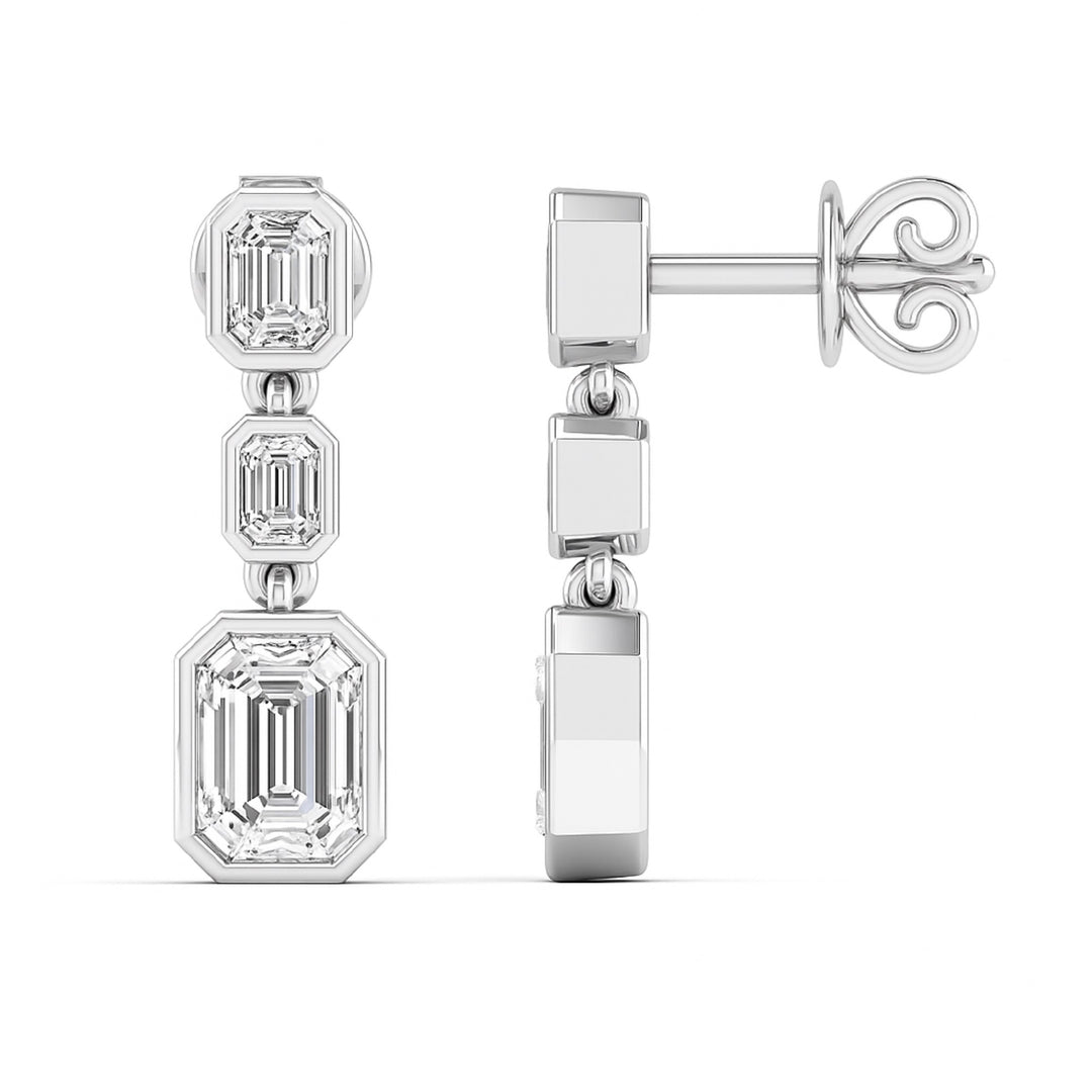 3 Emerald cut diamond dangling bezel set earrings in white gold