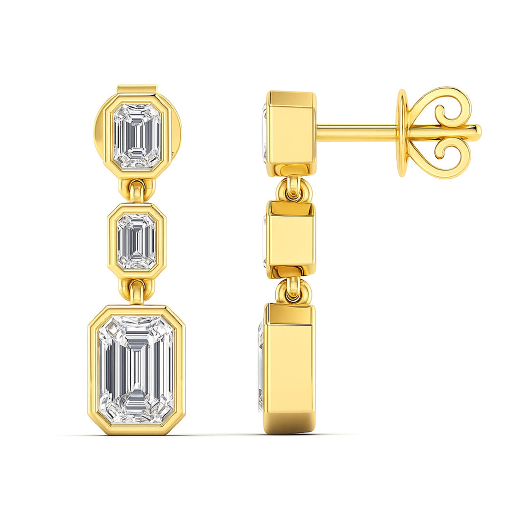 3 Emerald cut diamond dangling bezel set earrings in yellow gold