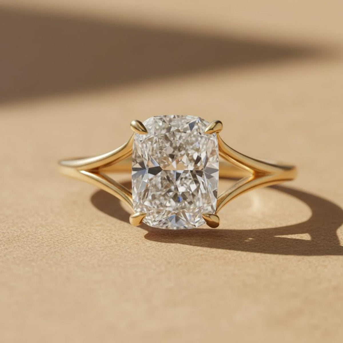 Elongated solitaire cushion cut split shank diamond ring in yellow gold