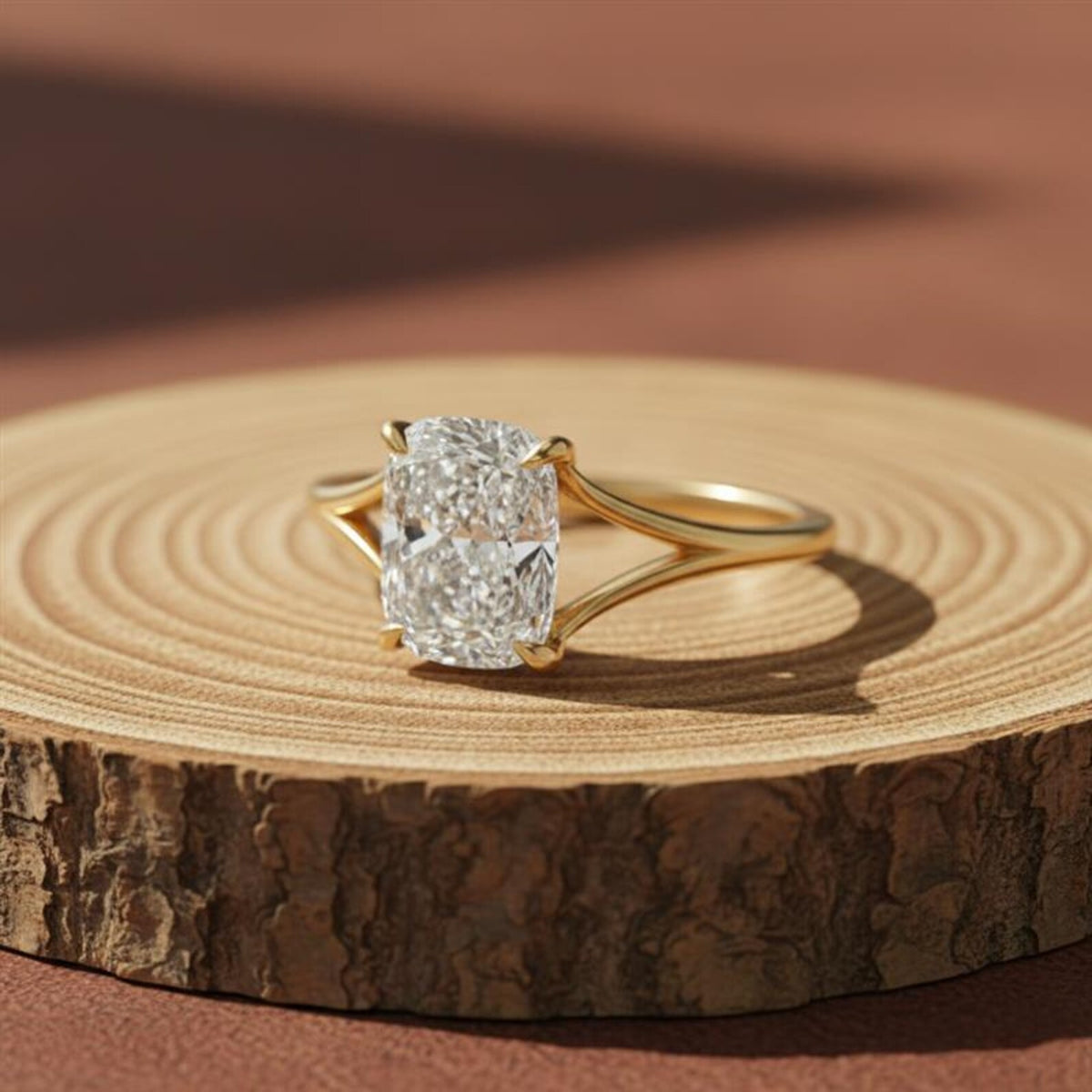 Elongated solitaire cushion cut split shank diamond ring in yellow gold