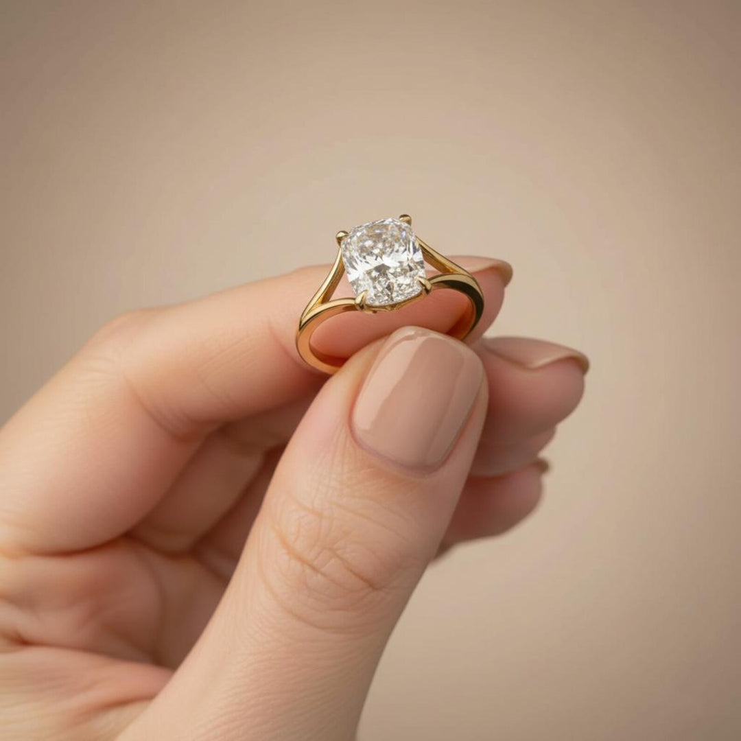 Elongated solitaire cushion cut split shank diamond ring in yellow gold with model holding the ring