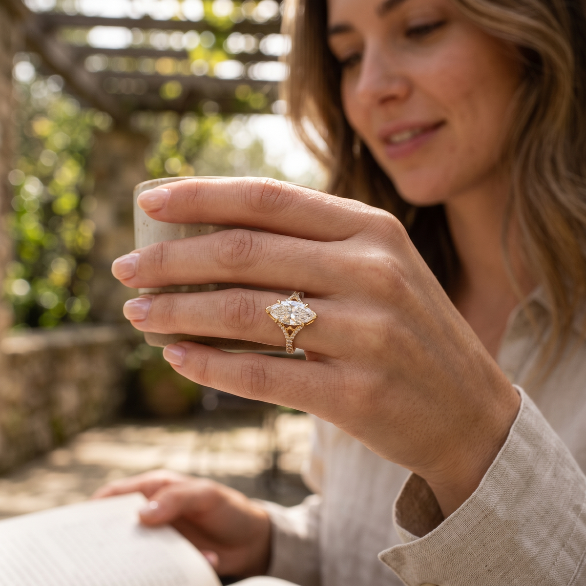 Marquise diamond  round u pave split shank ring in yellow gold on hand model