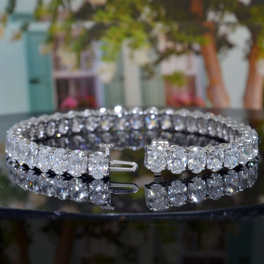 oval shape Diamond white gold bracelet showing lock of bracelet with a tree background