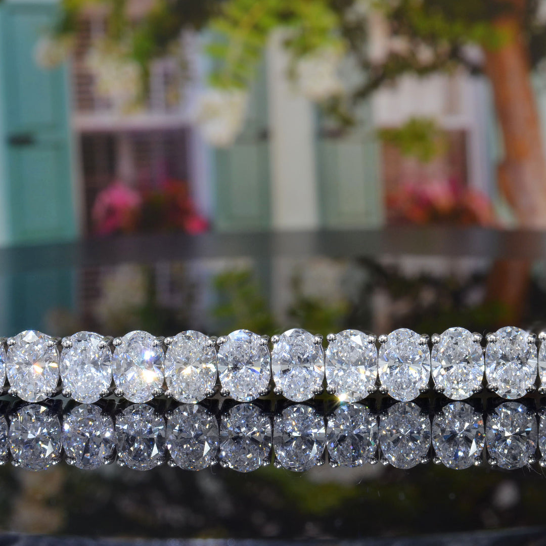 oval shape Diamond white gold bracelet   magnified with a tree background