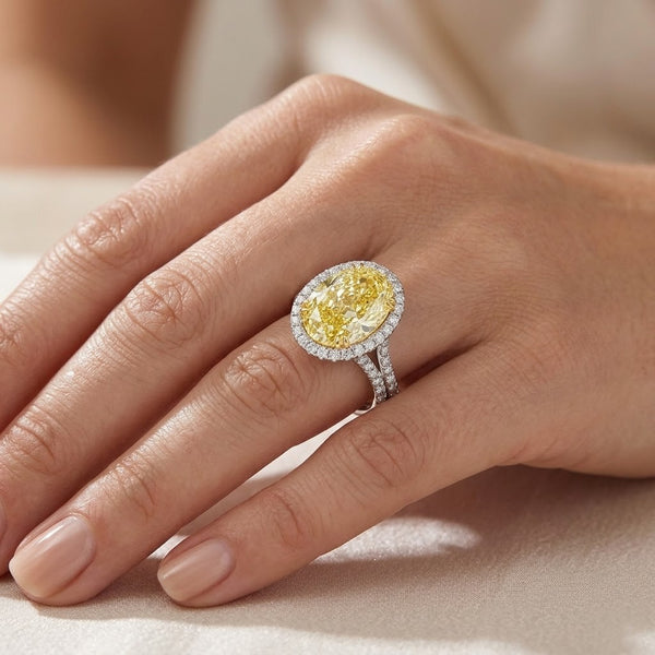 Oval Yellow diamond Halo Split Shank Pave Ring in white gold on model's ring finger