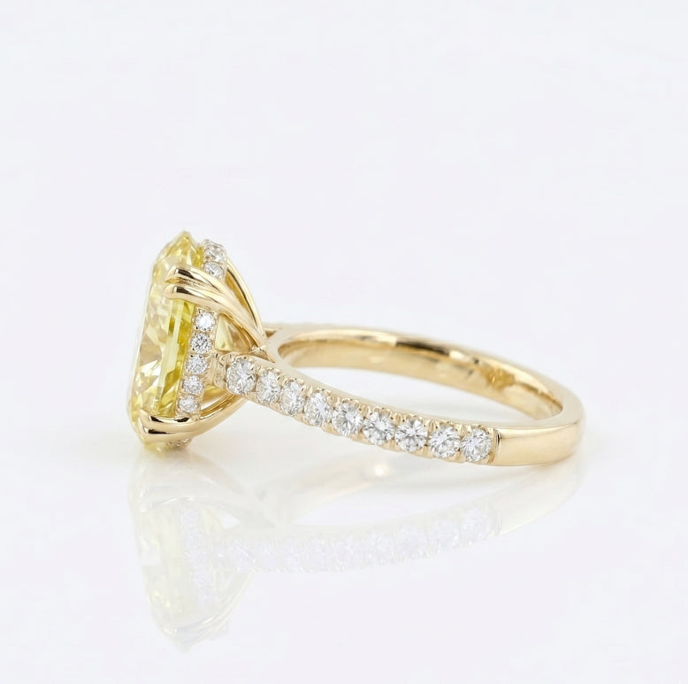 Oval Cut Diamond with Round Cut Pave in yellow gold ring side view