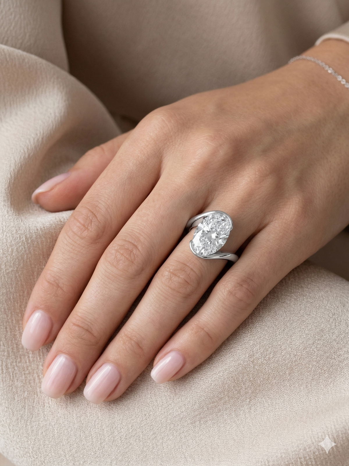 Oval cut diamond center bypass ring in white gold on model ring finger