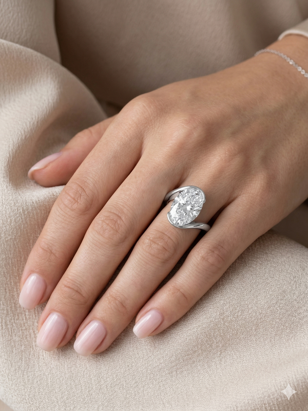 Oval cut diamond center Bypass ring in white gold on model ring finger