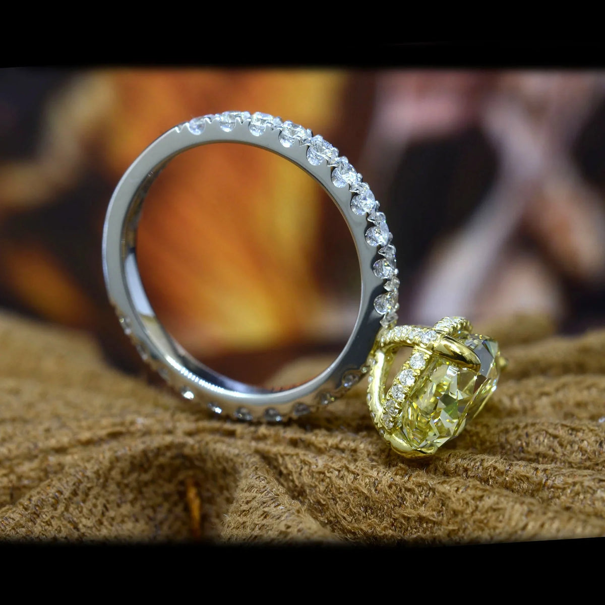 Yellow pear cut center diamond ring in white gold with yellow gold hidden halo prong head side profile