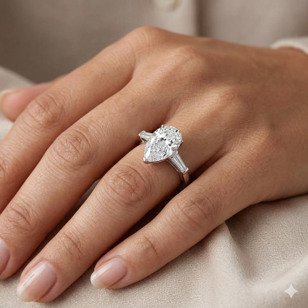 Pear cut & baguette 3 stone ring on model's hand