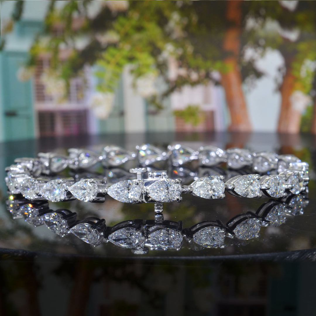 Diamond bracelet on a reflective surface with a blurred background
