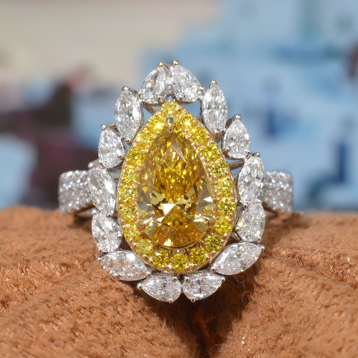 Pear cut yellow diamond center with double halo of marquise and pear & yellow round cut with 2 row shank diamond ring front view