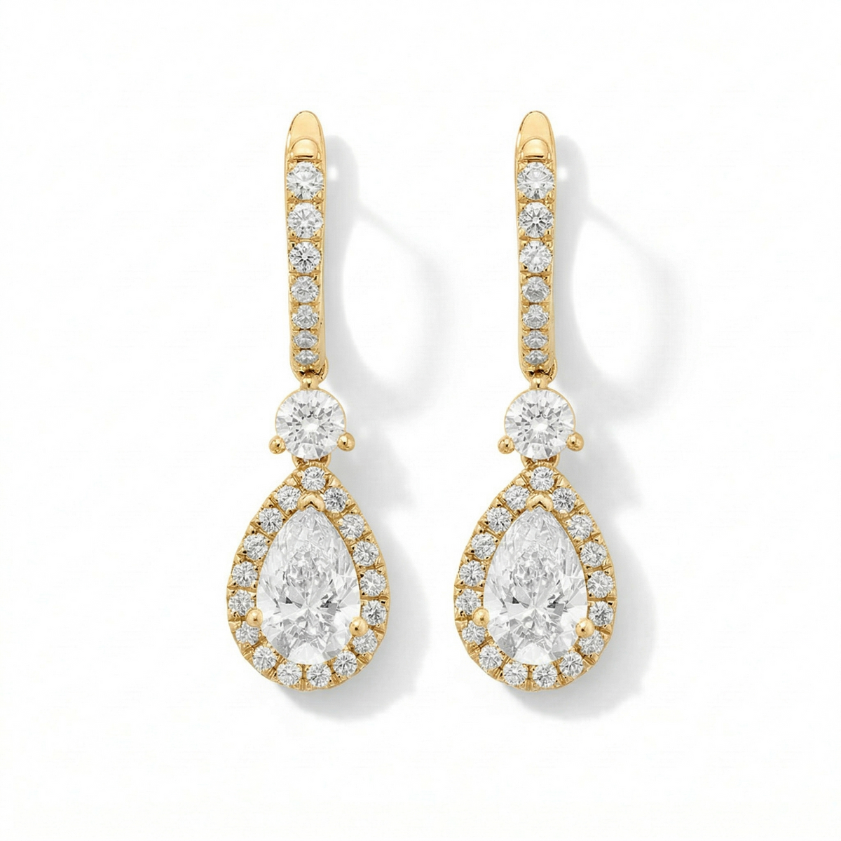 Gold and diamond earrings on a white background