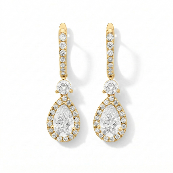 Gold and diamond earrings on a white background
