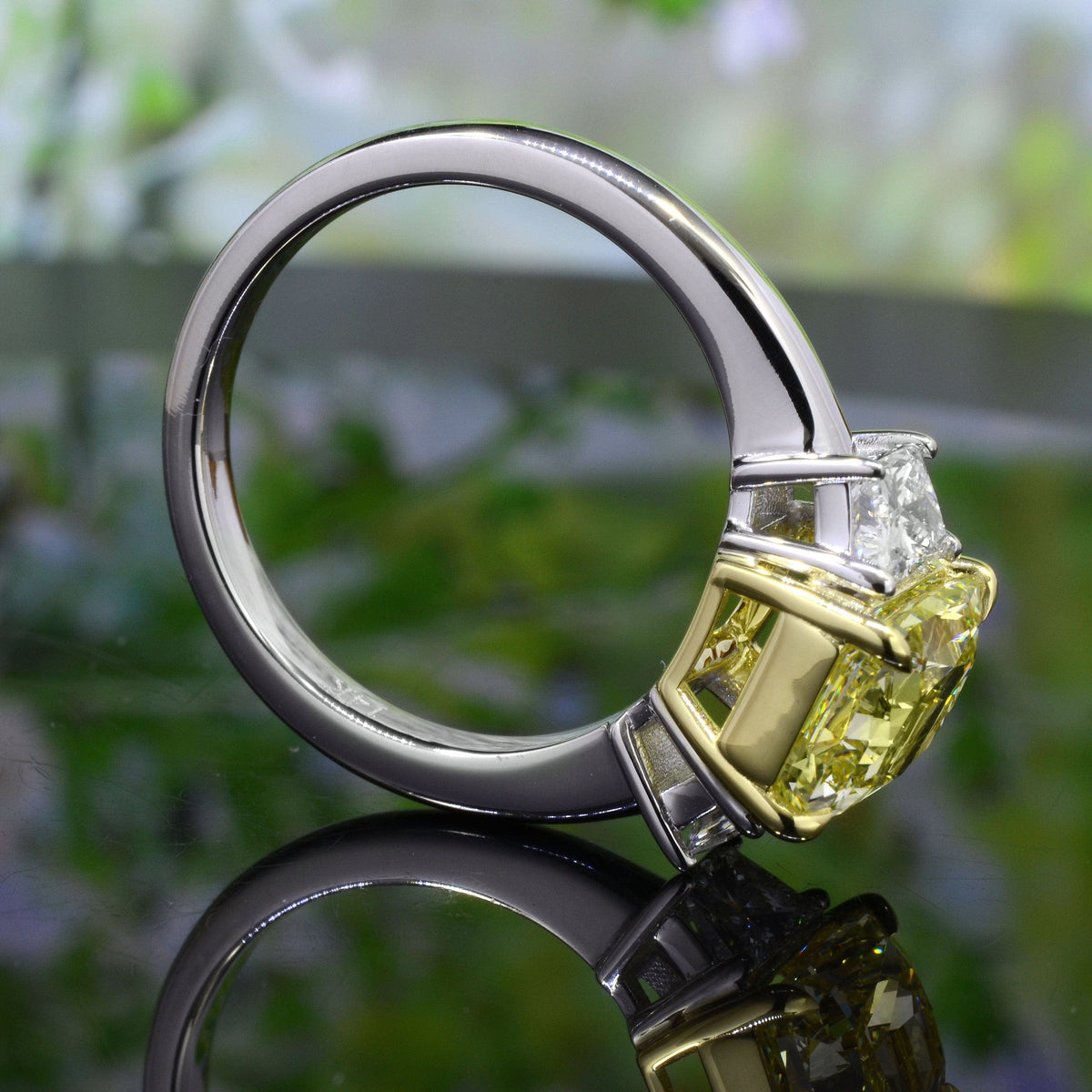 Elongated canary yellow radiant & trapezoids 3 stone ring side profile