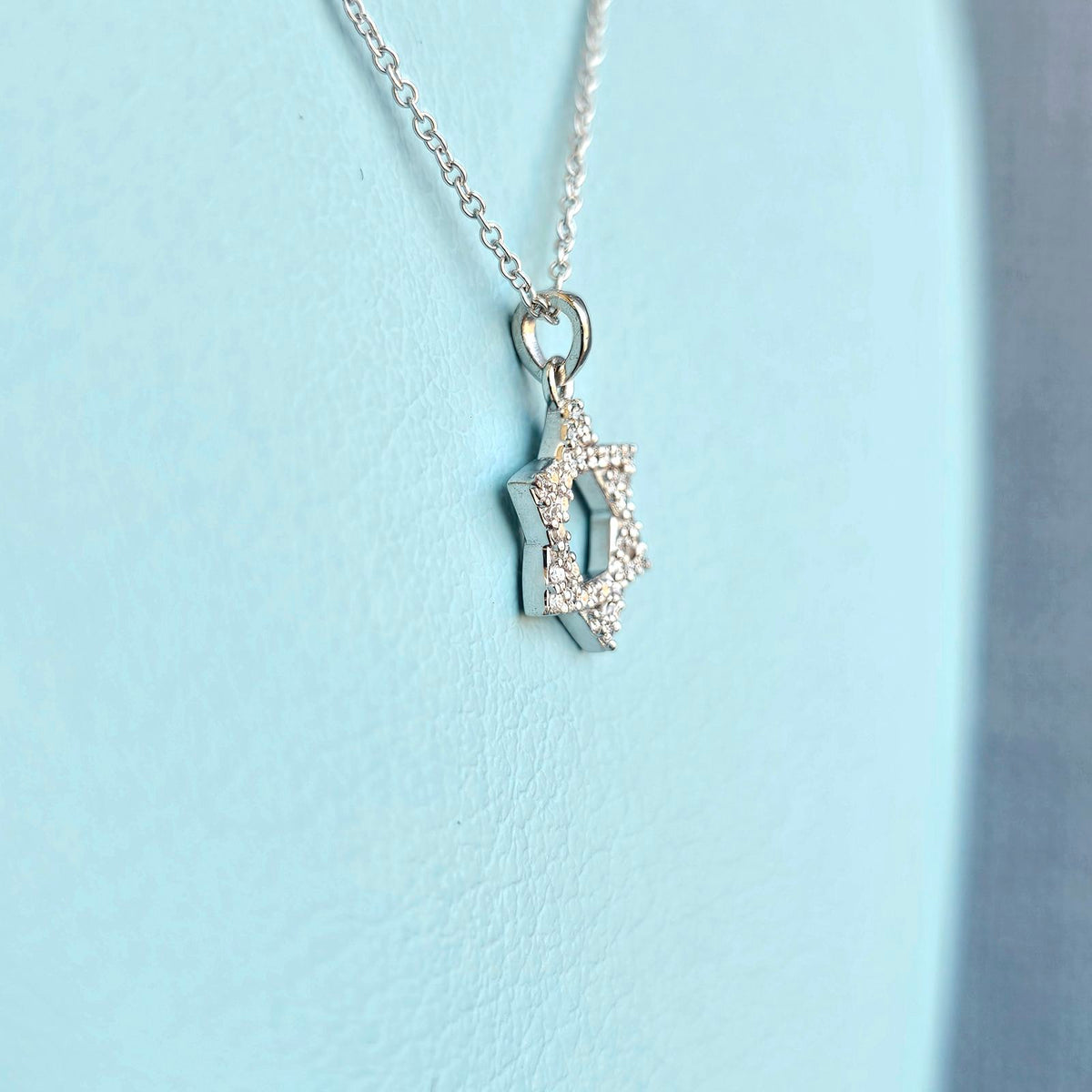 Pave set diamond star of david pendant with chain side view