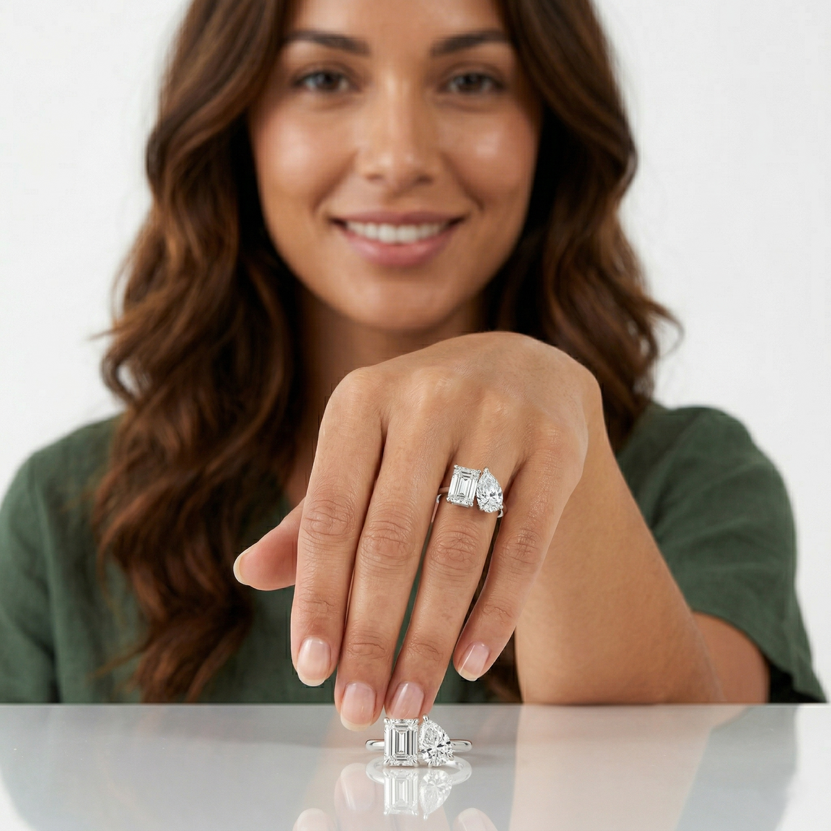 Toi et moi emerald & pear cut diamond ring on model ring finger
