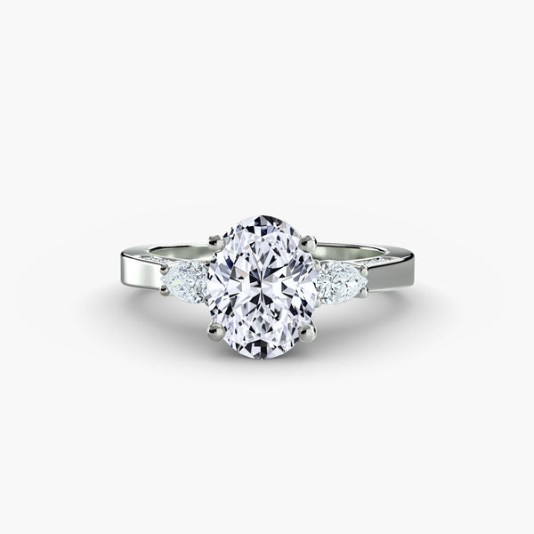 Three Stone Pear Cut with Subtle Round Cut Diamond Ring