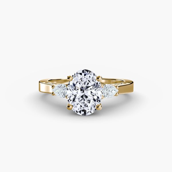 Three Stone Pear Cut with Subtle Round Cut Diamond Ring